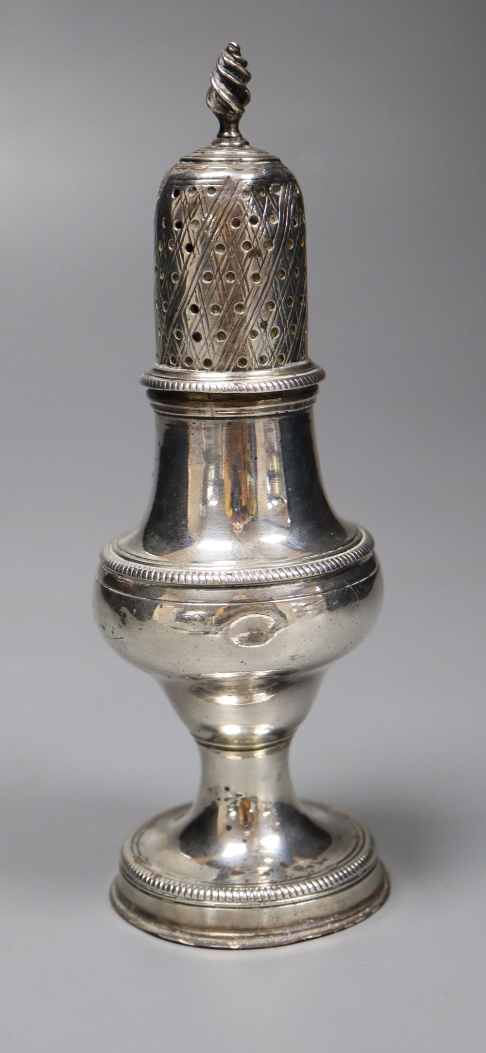 A George III silver pepperette, base Sutton & Bult, London, 1783, cap has makers mark for Hester Bateman?, 14.5cm, 80 grams.